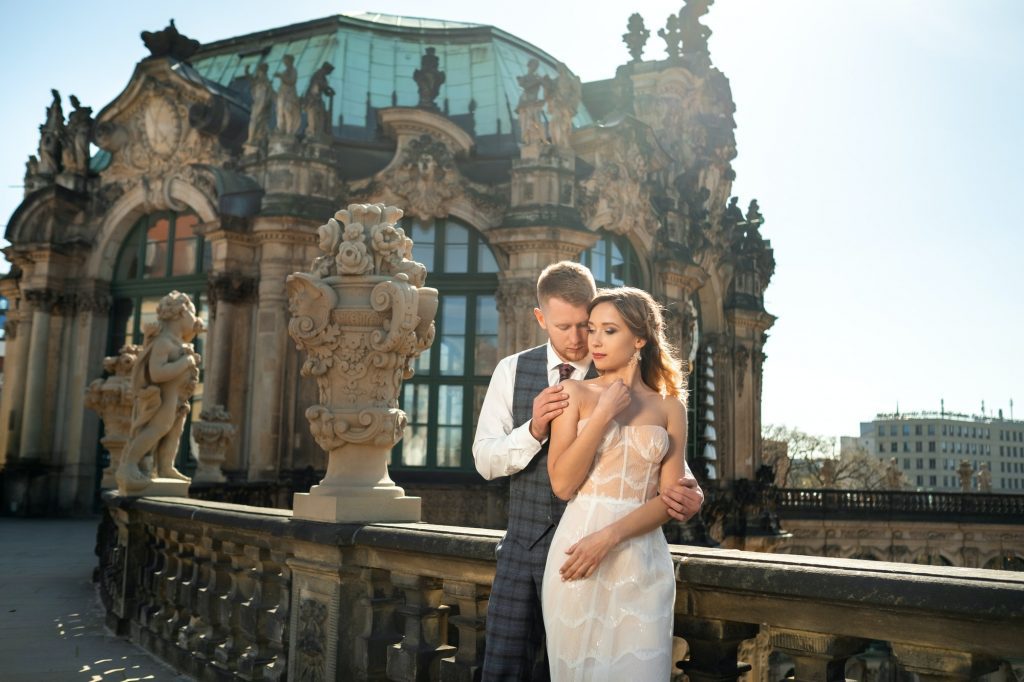 A couple in love on a wedding walk at the famous Baroque Zwinger Palace in Dresden, Saxony, Germany